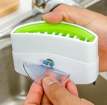 A creative kitchen cleaning brush with suction cup, perfect for washing knives, forks, chopsticks, fruits, and vegetables easily.
