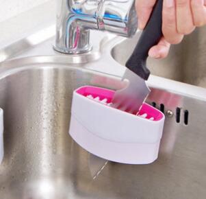 A creative kitchen cleaning brush with suction cup, perfect for washing knives, forks, chopsticks, fruits, and vegetables easily.